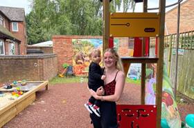 Mother carrying child in playground