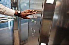 Person pressing button on lift