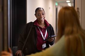 Person standing in doorway smiling