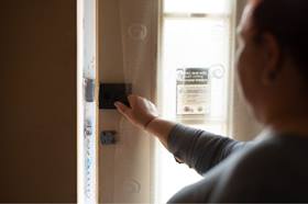 Woman locking door from inside her home