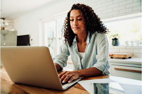 Lady using a laptop at home