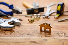 A selection of household tools and a small wooden house